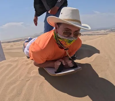 a man in a hat and sunglasses in the desert at Adanny Tours Peru in Lima