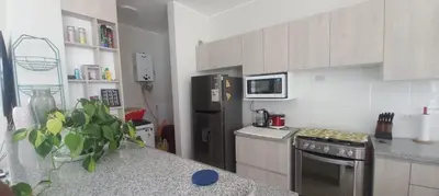 a kitchen with a refrigerator and a counter top at Casa de campo en Condominio in San Vicente de Cañete