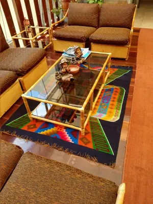 a coffee table on a rug in a living room at Hotel Rivera in Ayacucho