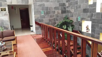 a staircase in a building with a stone wall at Hotel Rivera in Ayacucho