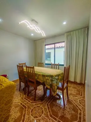 a dining room with a table and chairs and a window at Cusco Central Complete Apartment in Cusco