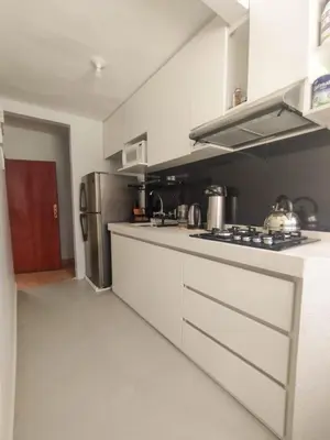 a kitchen with a stove and a refrigerator at Cusco Central Complete Apartment in Cusco