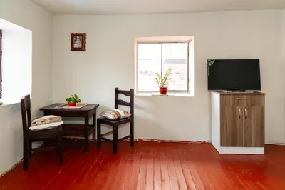 a living room with a television and a table and chairs at Munay Tika house in Cusco