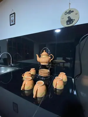 a kitchen counter with a tea pot on a stove at Casa Las Palmeras in Oxapampa