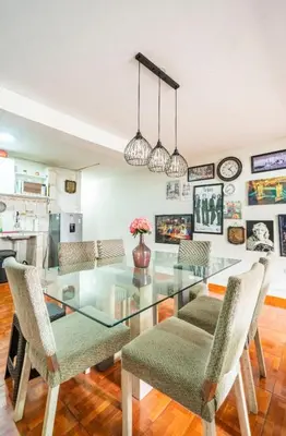 a dining room with a glass table and chairs at Lopez House Family Aparment in Lima