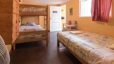a bedroom with two bunk beds and a window at Beraja Family Hostel in Lima