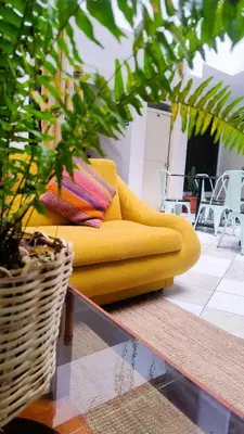 a yellow couch sitting on top of a room at Central Market Hotel San pedro in Cusco