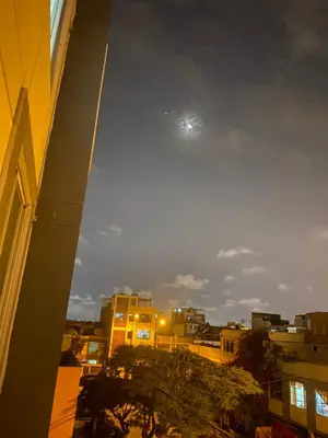 a view of a city with the moon in the sky at Sai in Lima