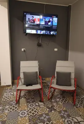 two chairs in a room with a tv on the wall at Casa sabina hostel in Lima