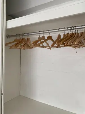 a closet with lots of wooden hangers at e-t*| Apartamento frente al mar in Cerro Azul