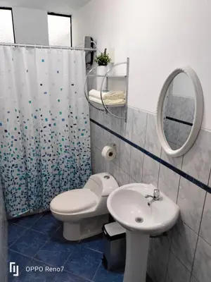 a bathroom with a toilet and a sink and a mirror at Warmisitay Mini departamento in Lima