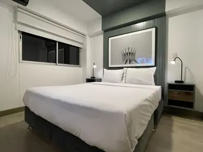 a large white bed in a room with a window at Connect Studios by Vibrant in Lima