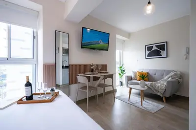 a bedroom with a bed and a living room at Connect Studios by Vibrant in Lima