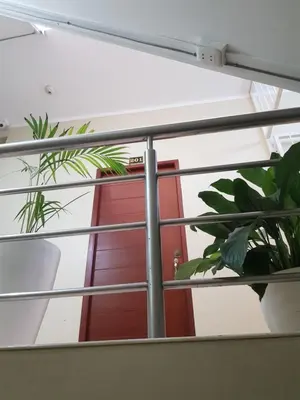 a window with a red door and some plants at Paloma House in Lima