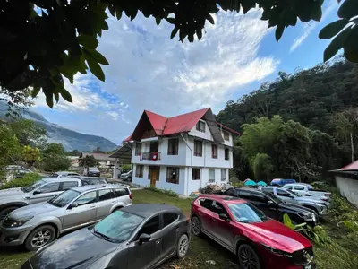 a group of cars parked in front of a house at Hospedaje Casablanca in Pozuzo