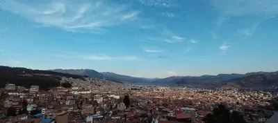 a view of a city with mountains in the background at Panoramic Cusco in Cusco