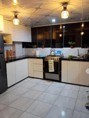 a kitchen with black and white cabinets and appliances at Panoramic Cusco in Cusco