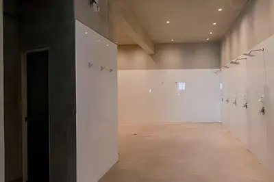an empty room with white walls and a hallway at Condominio Ocean reef in San Bartolo