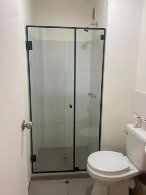 a glass shower in a bathroom with a toilet at Entire Apartment 20 min from airport - Cozy and Secure in Lima