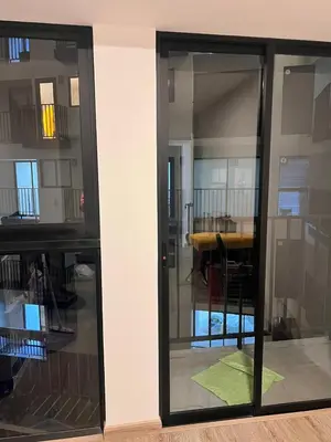 a glass door with a table in a room at Pacific apartamento Miraflores in Lima