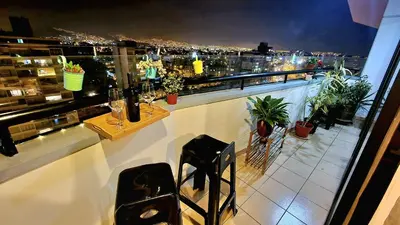 a balcony with a view of a city at night at Habitación con Baño privado en Departamento Compartido in Lima