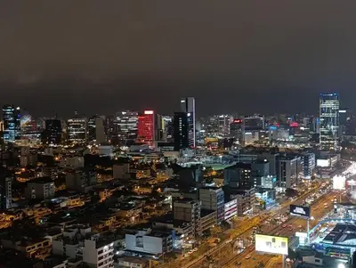 a city lit up at night with at Piso 31, Último piso, con vista Panorámica in Lima