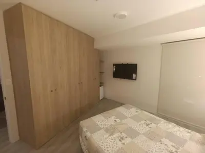 a bedroom with a bed and a flat screen tv at Piso 31, Último piso, con vista Panorámica in Lima
