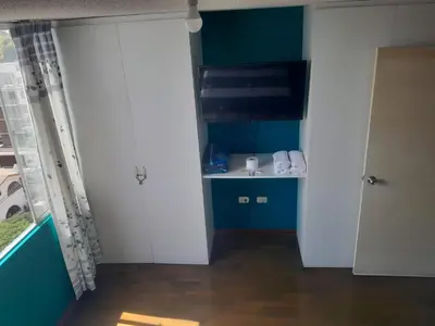 a room with a bathroom with a sink and a door at San Miguel Rooms Lima Airport B&B in Lima