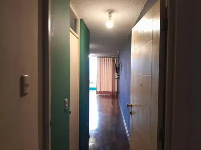 an empty hallway with green and blue walls at San Miguel Rooms Lima Airport B&B in Lima