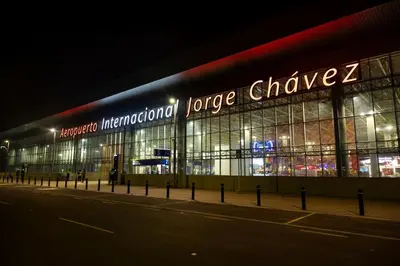 a large building with a sign on it at night at San Miguel Rooms Lima Airport B&B in Lima