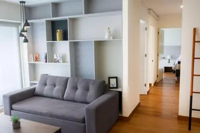 a living room with a gray couch in a room at Comfort and Space 3bed and 2 and haf bath centric location in Lima