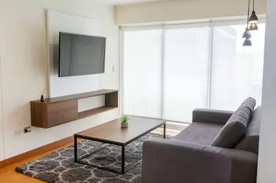 a living room with a couch and a coffee table at Comfort and Space 3bed and 2 and haf bath centric location in Lima