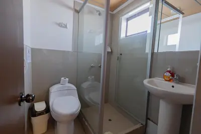 a bathroom with a toilet and a shower and a sink at Andes House Cusco in Cusco