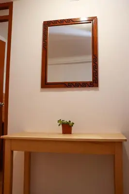 a mirror on a table with a plant on it at Andes House Cusco in Cusco