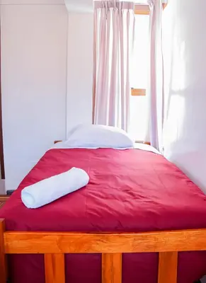 a bed with two white pillows on top of it at Andes House Cusco in Cusco