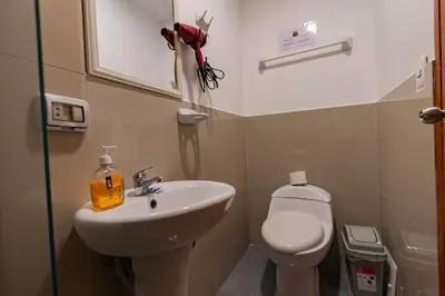 a small bathroom with a sink and a toilet at Andes House Cusco in Cusco