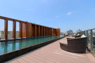 a balcony with a swimming pool on top of a building at Living 110 Suites by Wynwood House in Lima