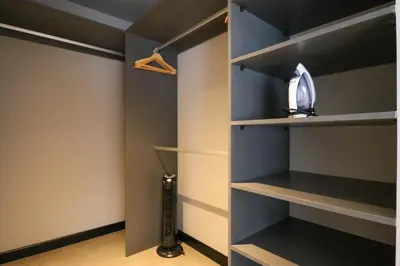 a walk in closet with blue walls and shelves at Living 110 Suites by Wynwood House in Lima