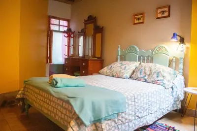 a bedroom with a bed in a room at Soy y Luna- ECOALBERGUE RETABLOS PERU in Lunahuaná