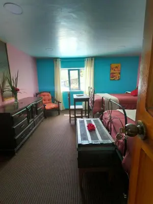 a living room with a couch and a table at Casa Jazmín Hospedaje Familiar Eco Amigable - Huayoccari, Sacred Valley in Huayoccare