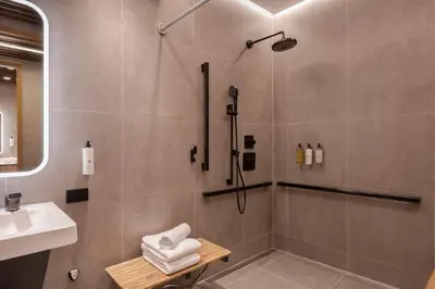 a bathroom with a shower and a sink at Sleepover - Lima Airport, the only in-terminal sleep pods in Lima