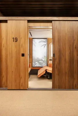 an open door to a room with a bed at Sleepover - Lima Airport, the only in-terminal sleep pods in Lima