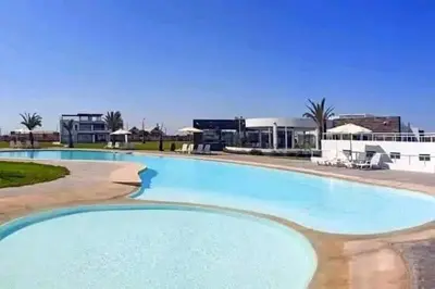 a large blue swimming pool in a resort at Condominio Nautico Paracas in Ica