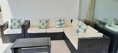 a living room with a couch and a table at Condominio Nautico Paracas in Ica