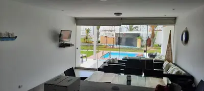 a living room with a view of a pool at Condominio Nautico Paracas in Ica