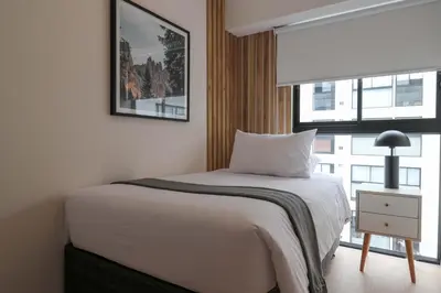 a bedroom with a white bed and a window at Barron by Wynwood House in Lima