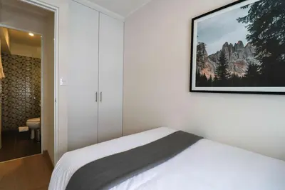 a bedroom with a bed and a picture on the wall at Barron by Wynwood House in Lima
