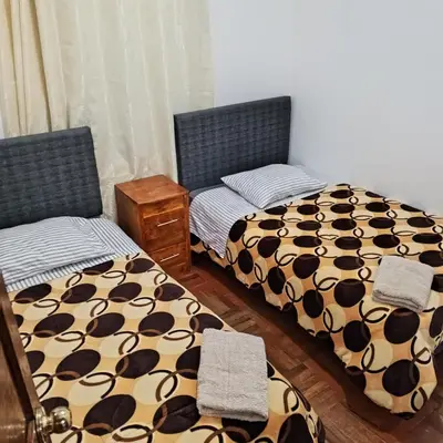 two beds sitting next to each other in a bedroom at Hospedaje Rochi House - Cusco- En el Corazón del Cusco in Cusco