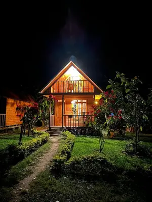 a house at night with the lights on at Palo Alto Lodge in Oxapampa