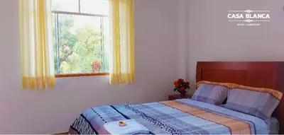 a bedroom with a bed and a window at HOTEL HUAYTARA CasaBlanca in Huaytará